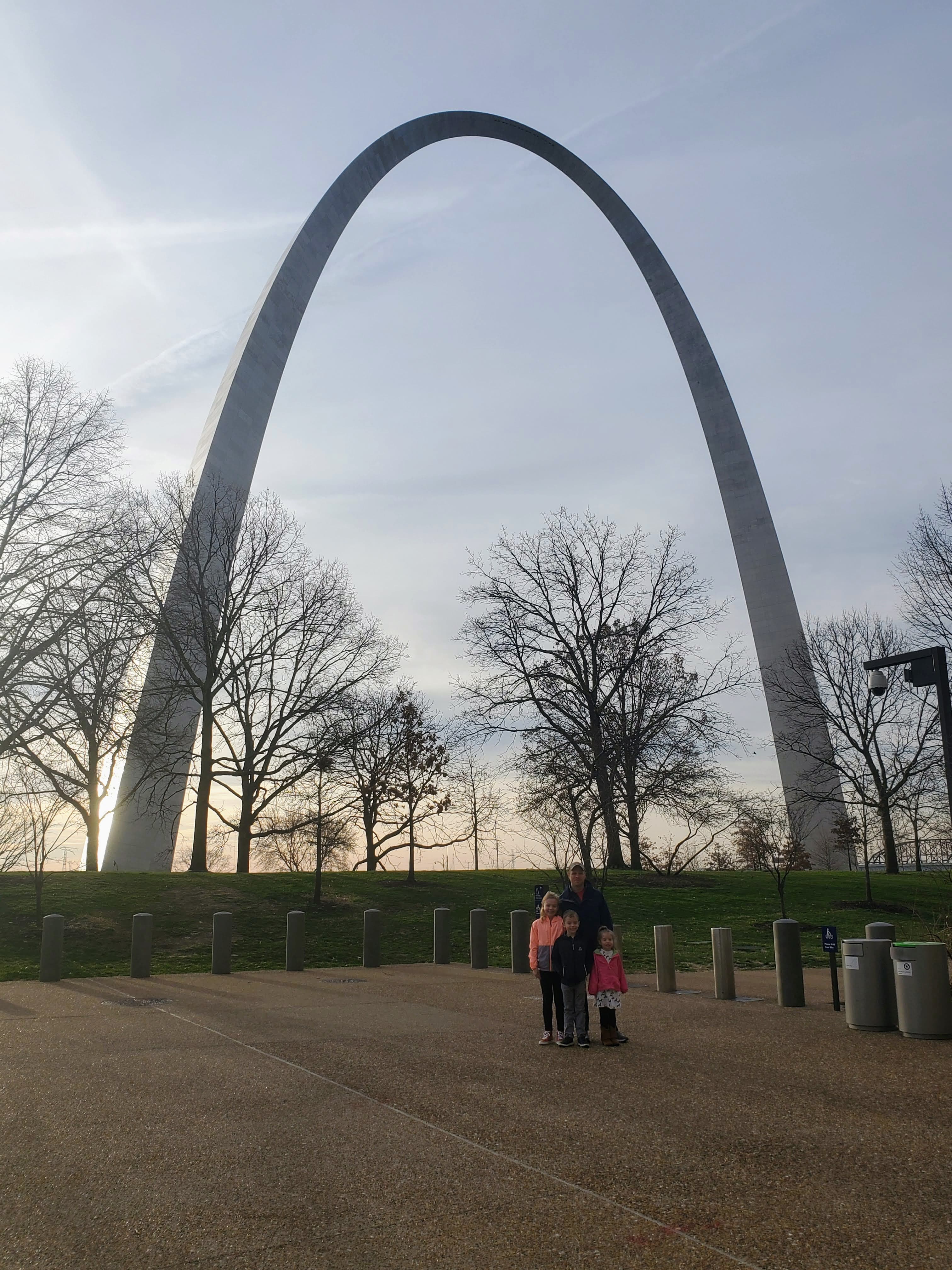 View of the St. Louis arch and trees at dusk