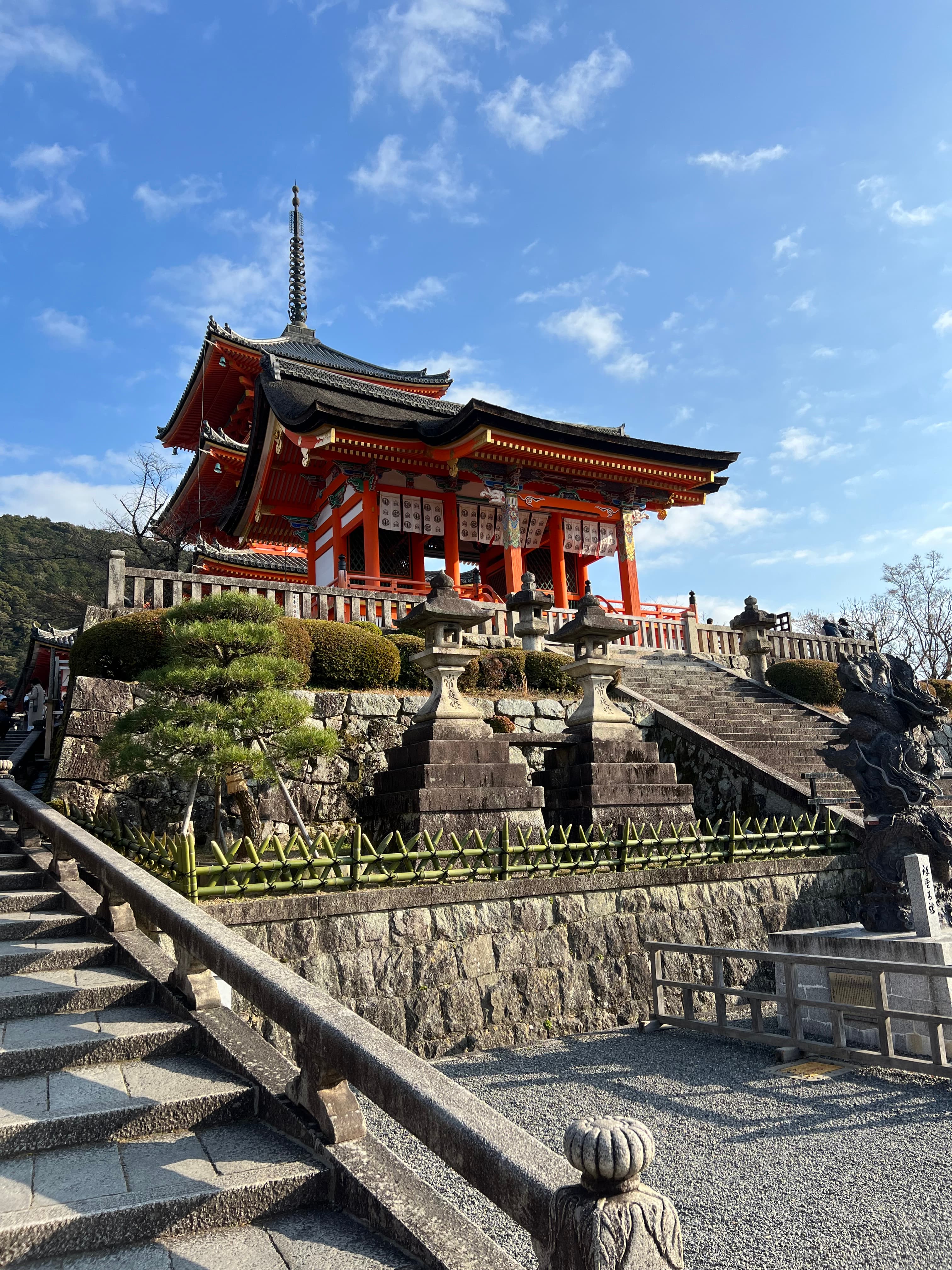 Traditional red building and gardens.