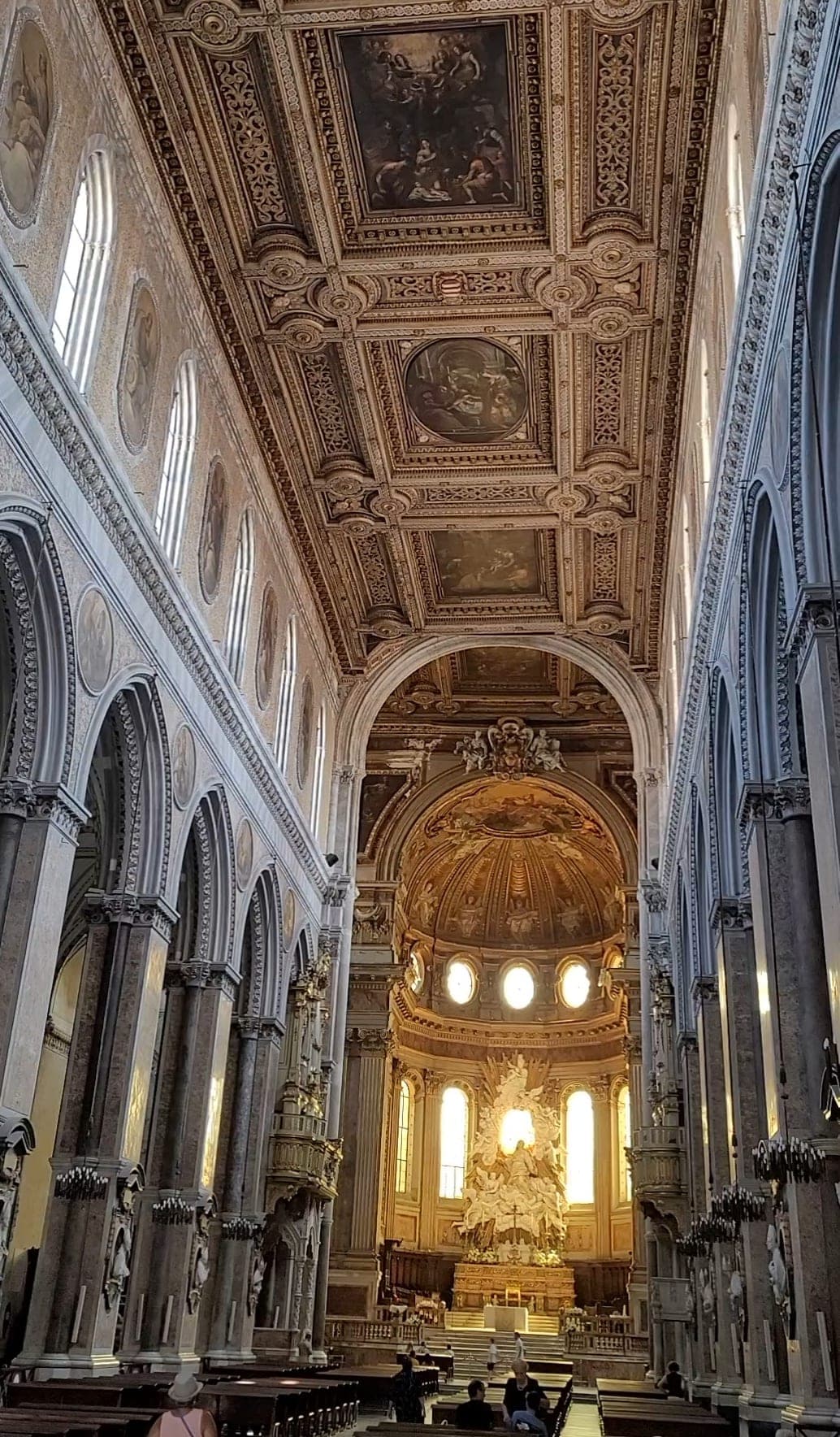 Interior view of a cathedral with high ceilings and columns on either side of the center chamber