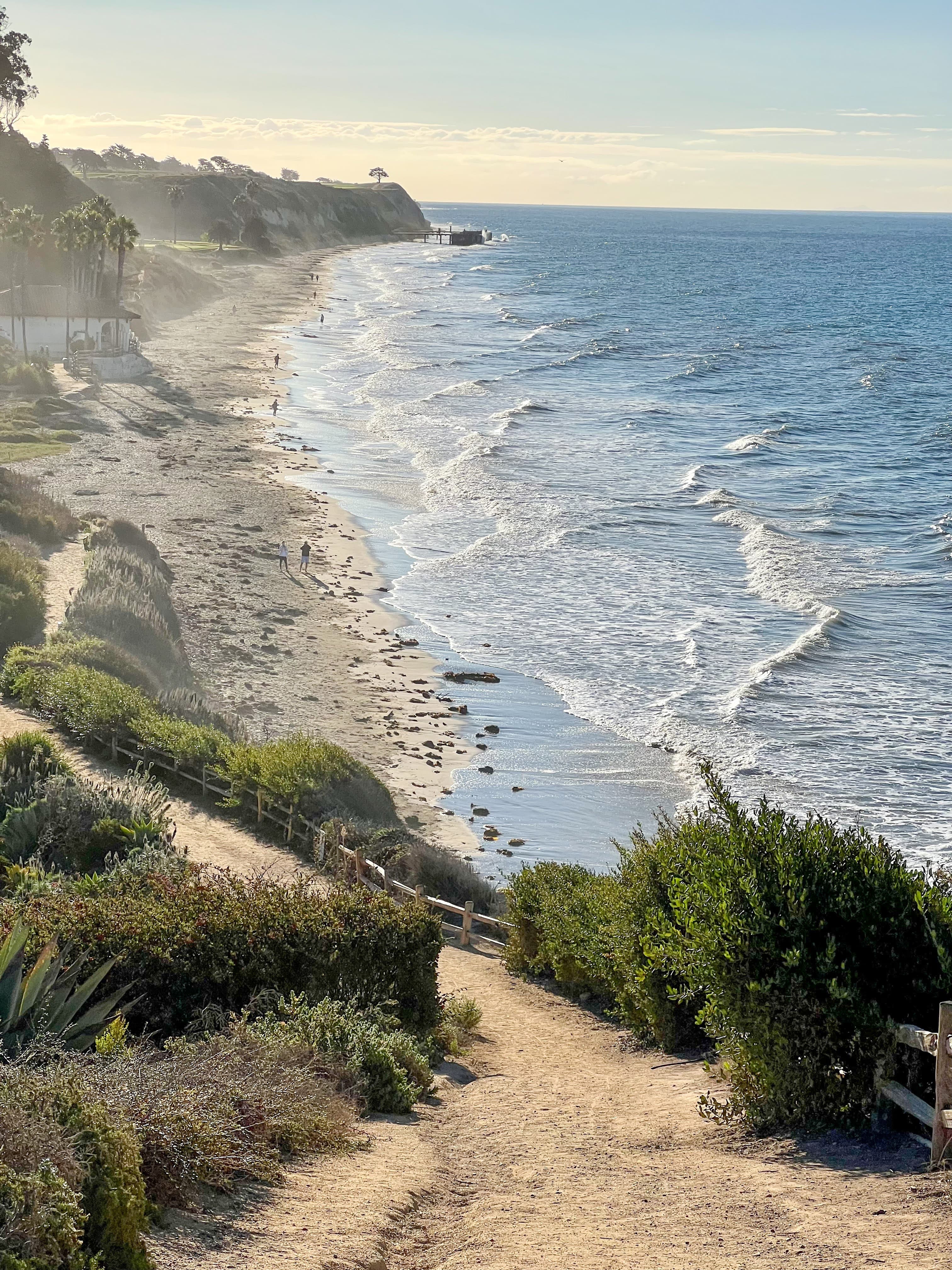 View of a beautiful beach stretching down the coastline on a sunny day