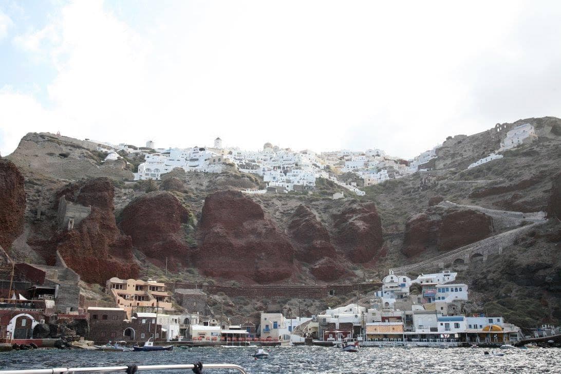 View of a city with a grand mountain in the background during the daytime.