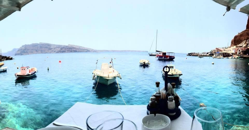 View of the ocean full of boats on the water during the daytime.