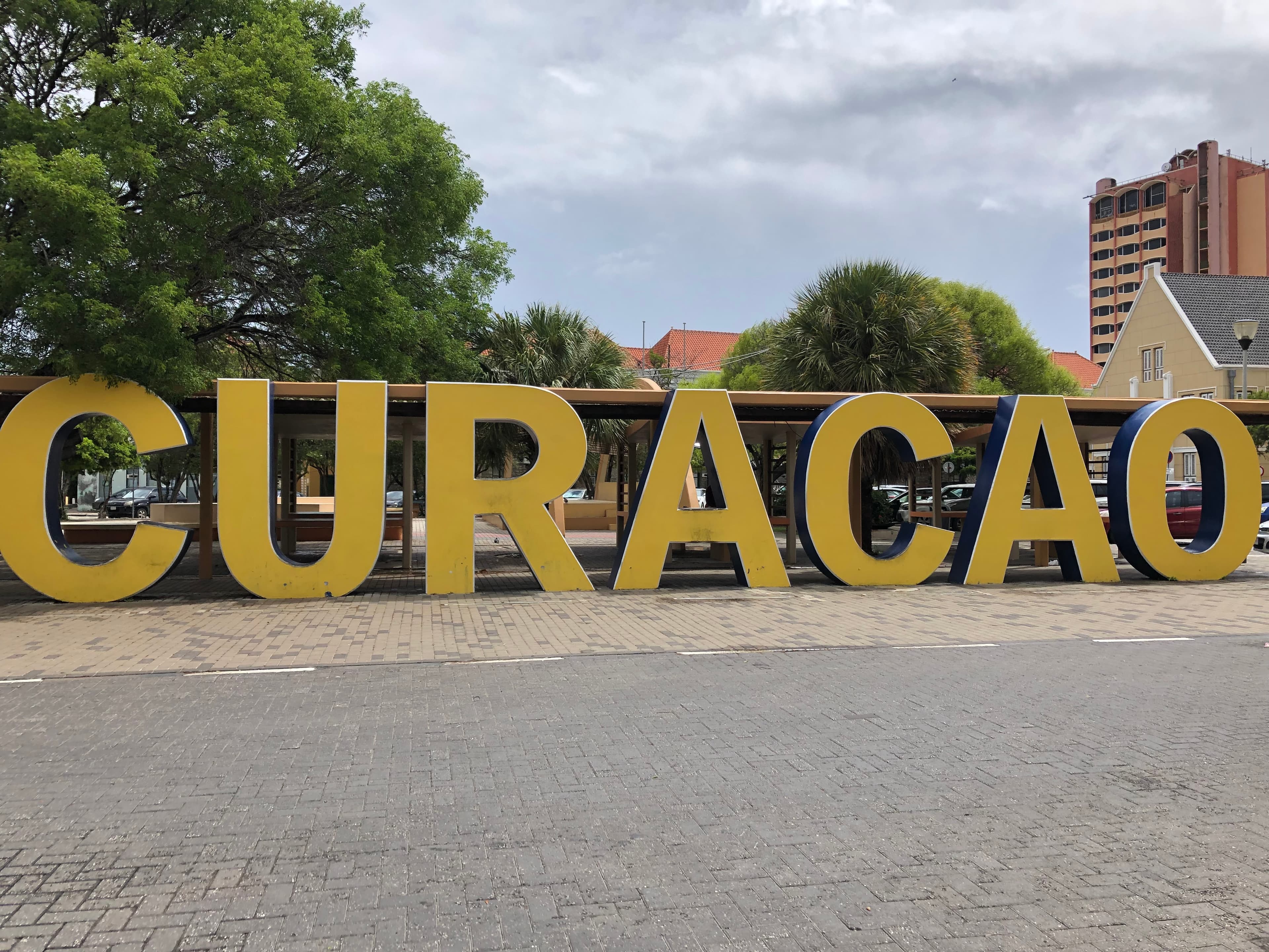 A sign of Curacao during the daytime. 