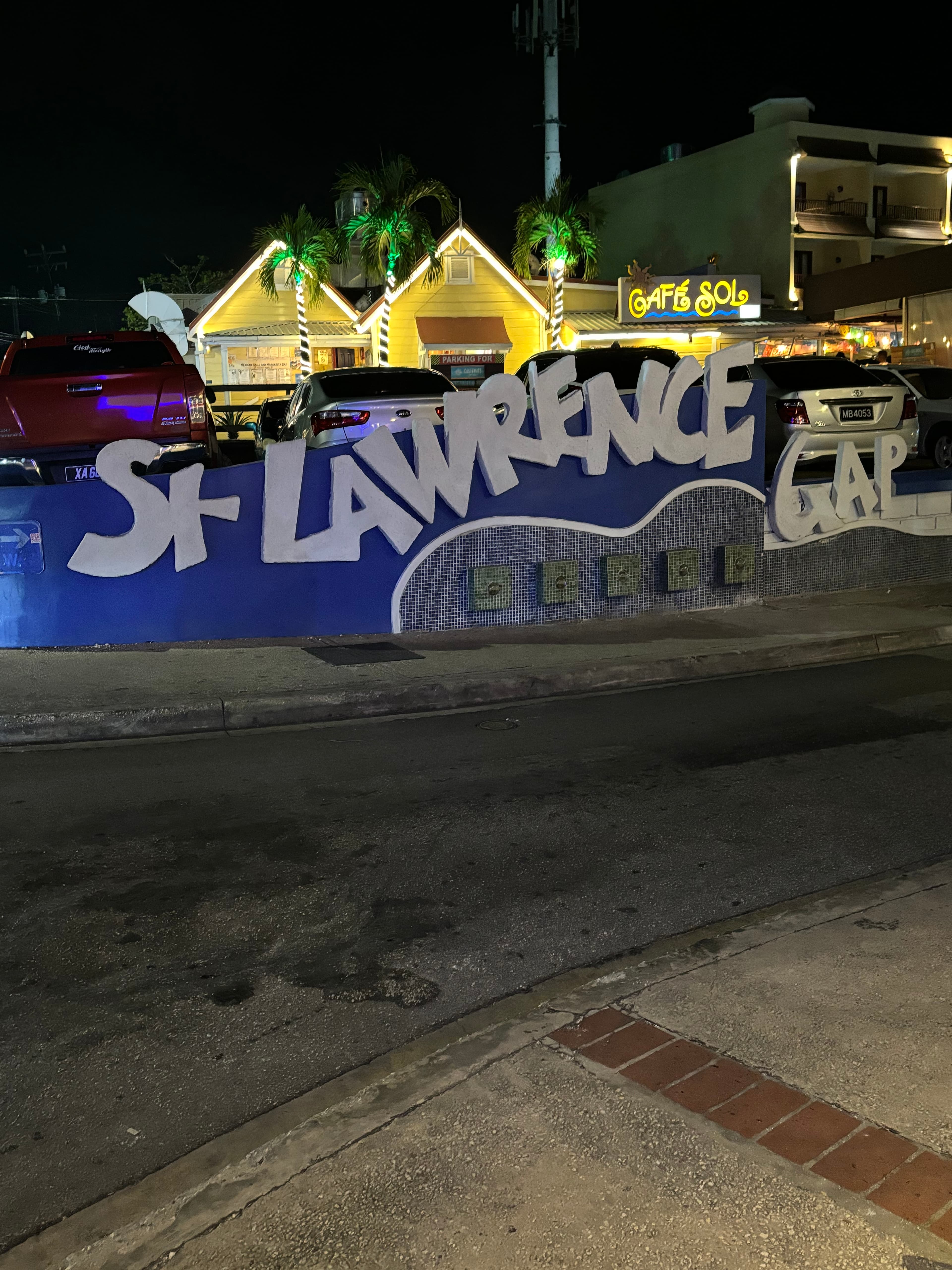 An image of a St Lawrence town sign at night with lights. 