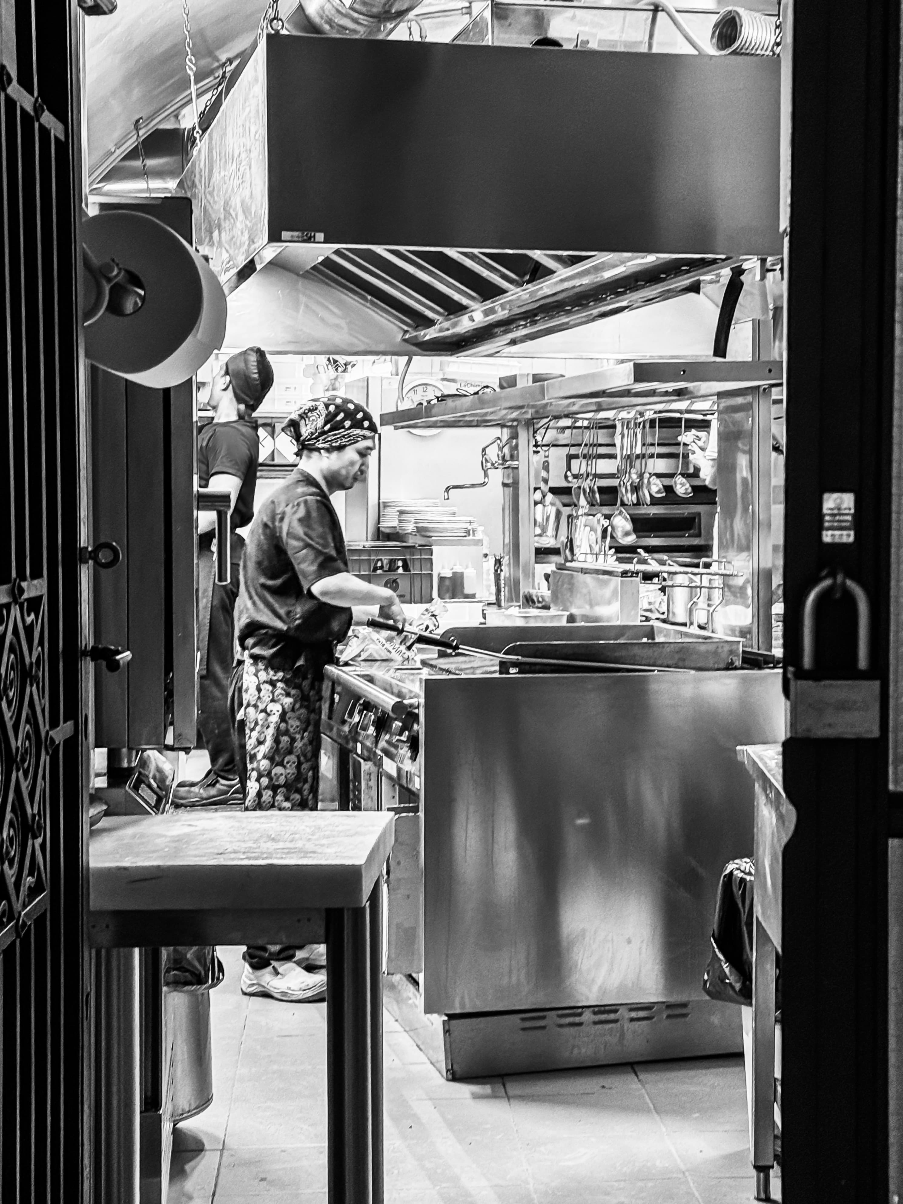 An image of a chef preparing food in a kitchen.