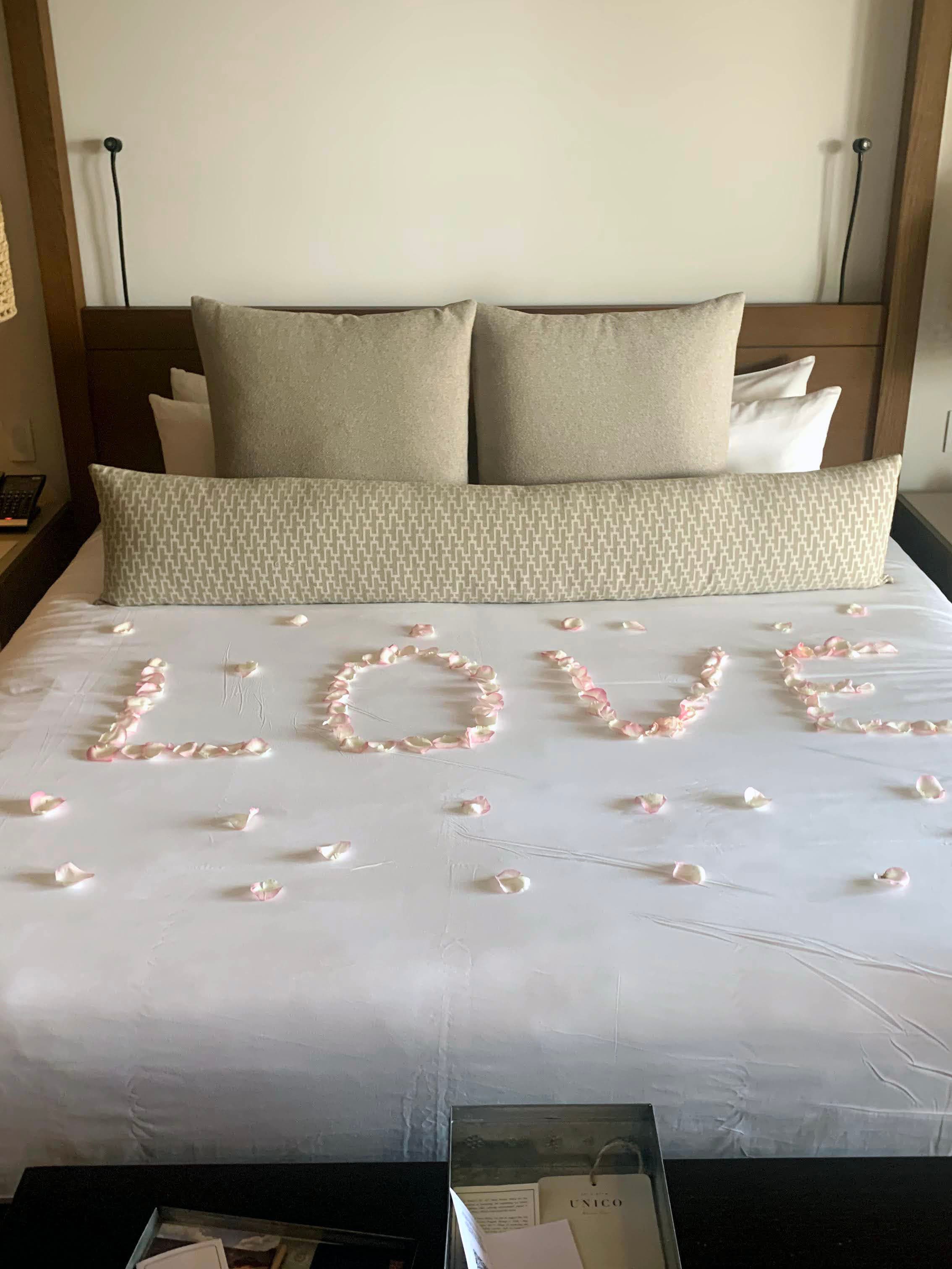 Love in petals on bed.