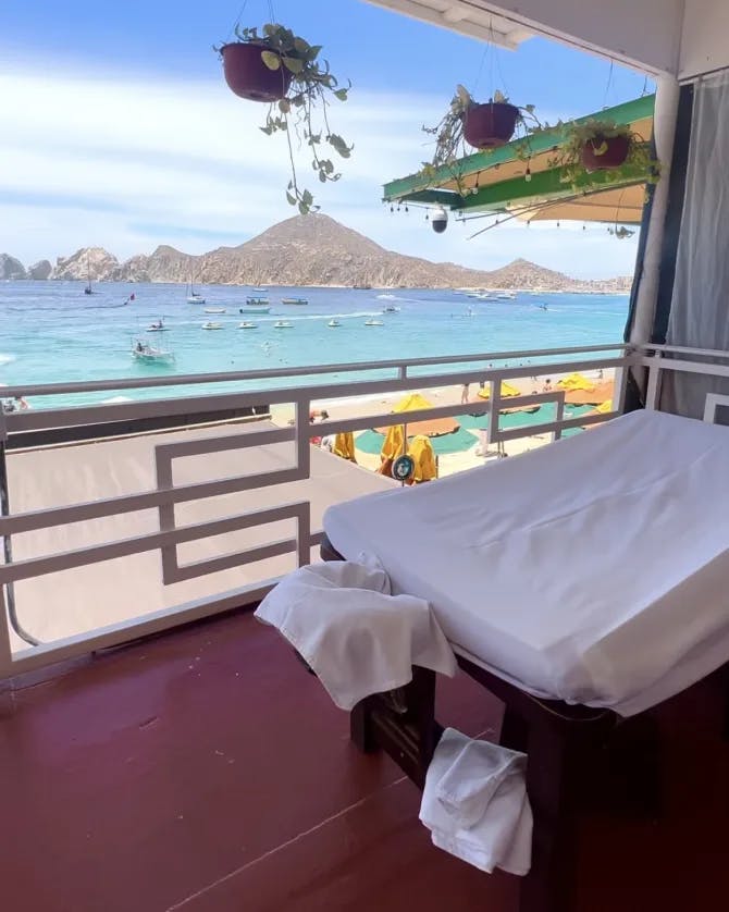 Picture of a spa on the ocean with a mountains in the distance 