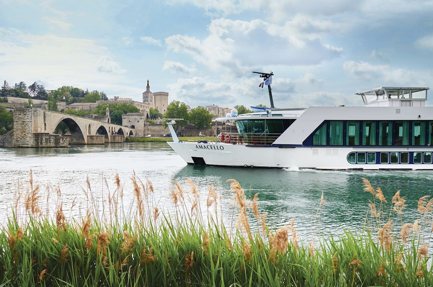 a white river cruise near an old European city