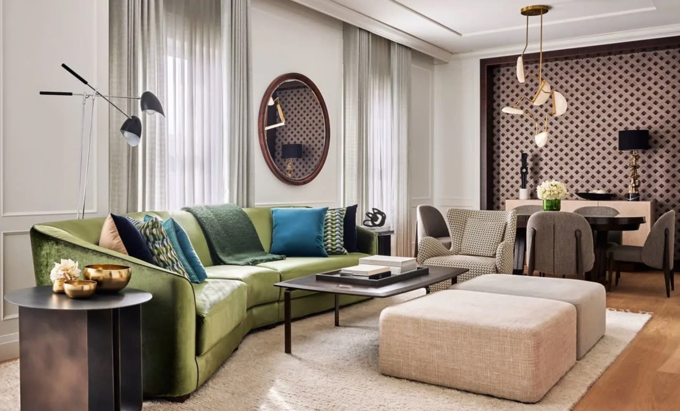 colorful green and blue couch and table and chairs with contemporary lighting