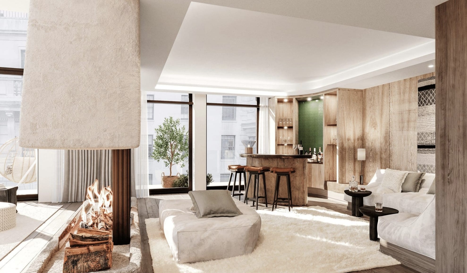 A suite living room in earthy tones with a bar, fireplace and cream seating