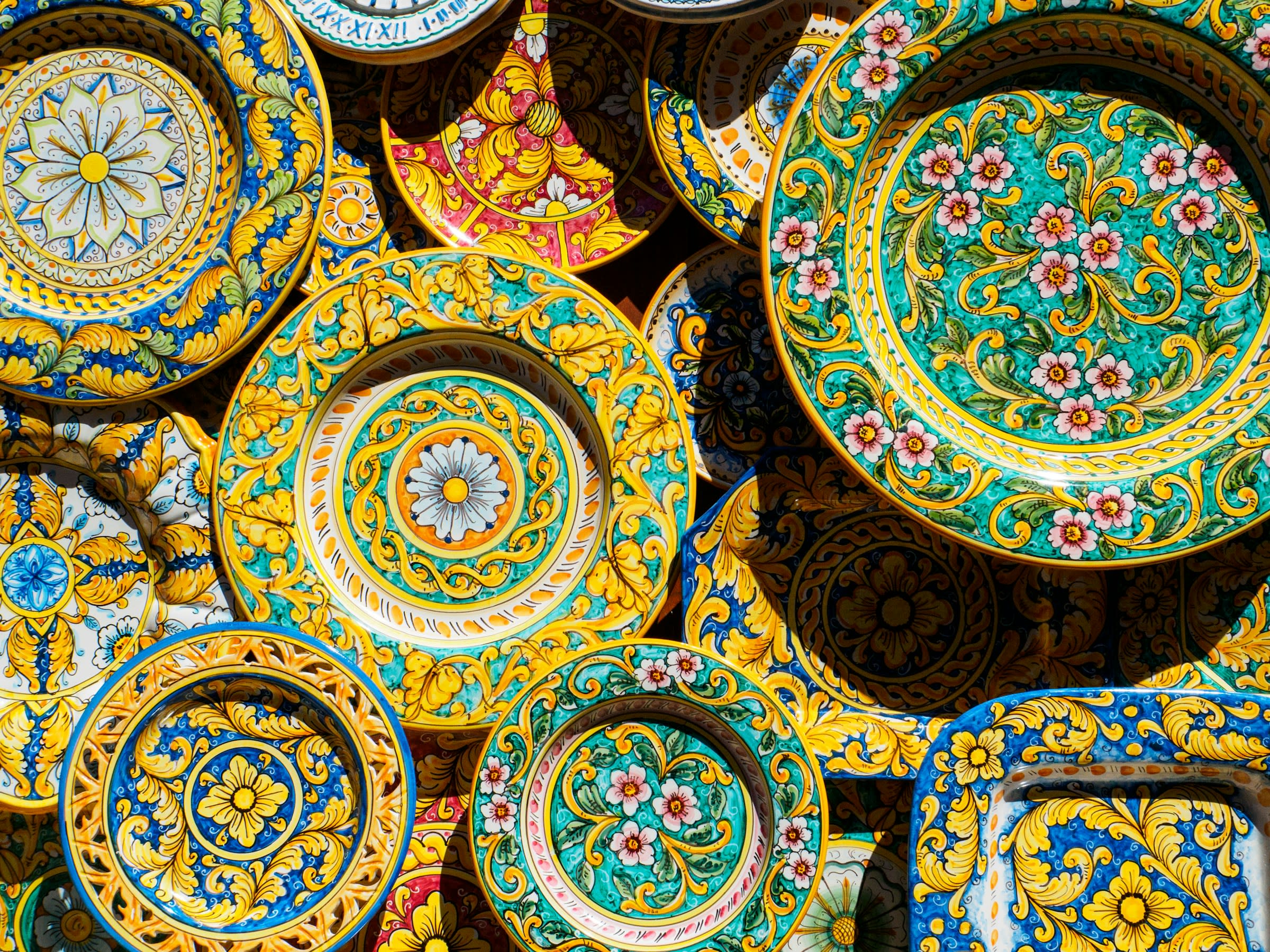 Wall of brightly colored hand painted ceramic plates