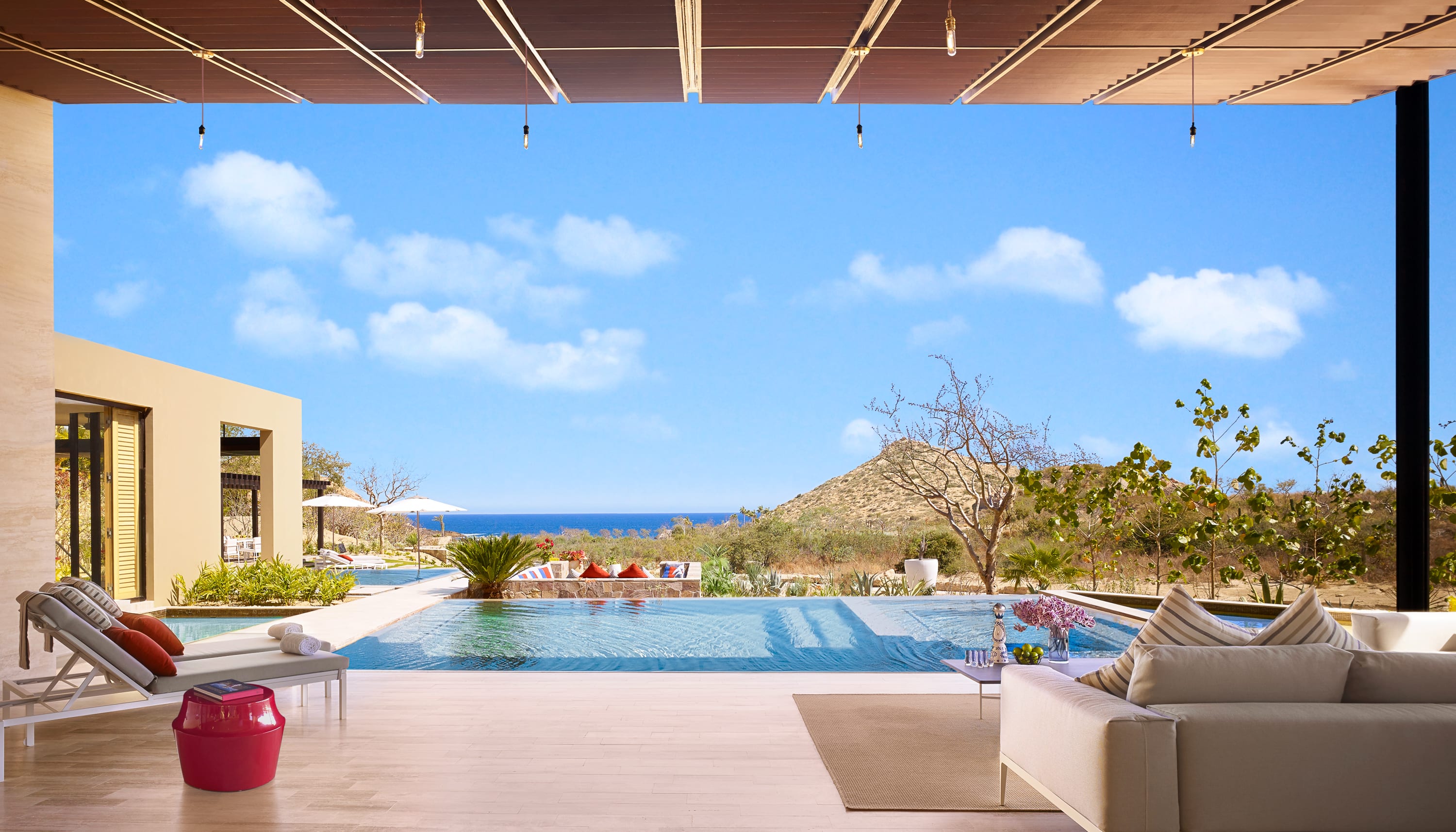 A large pool and terrace area of a home with ocean views
