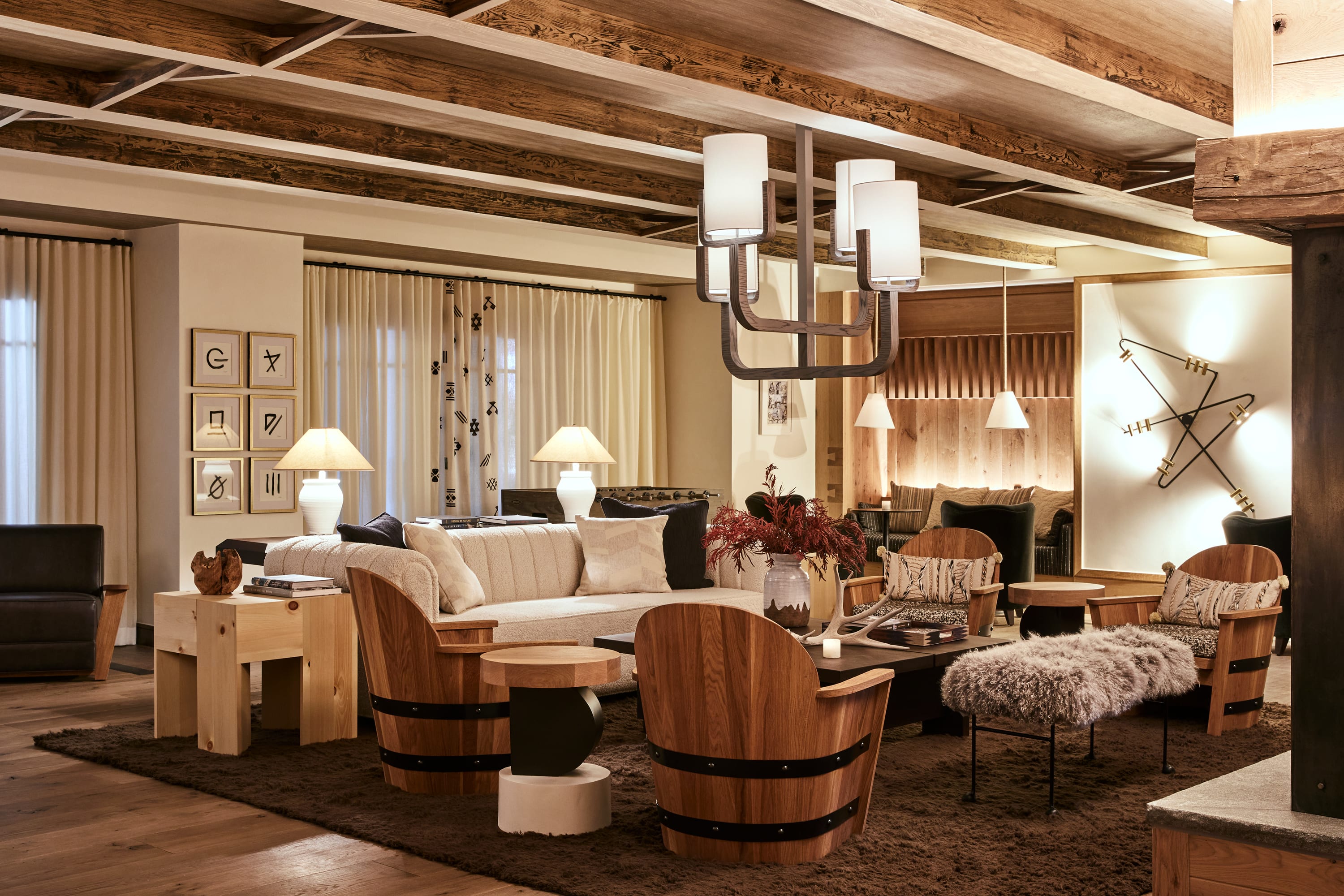 A cozy and elegant lounge area at a hotel with warm lighting and brown and cream furnishings