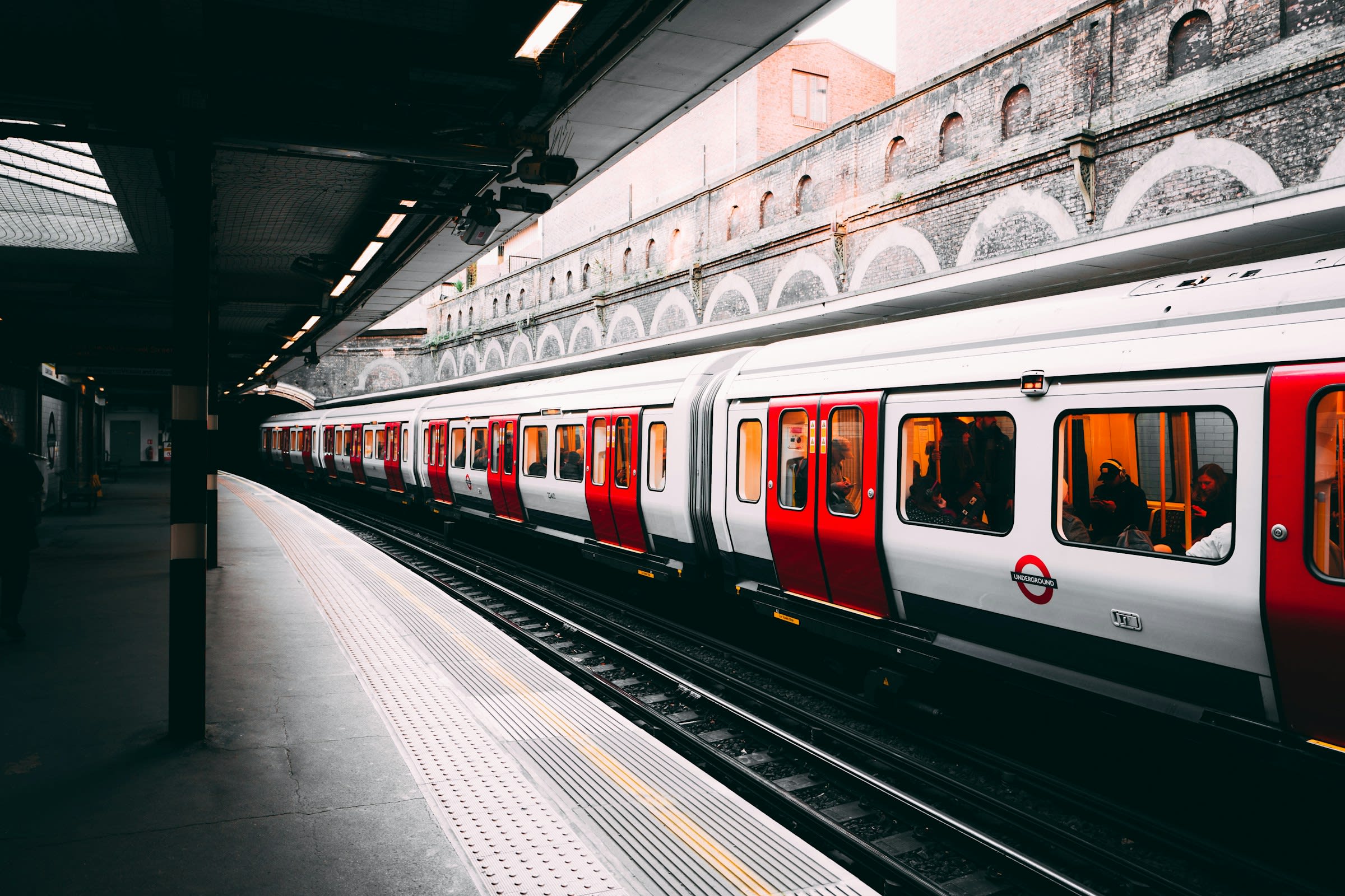 View of a white and red subway train at a station in daytime
