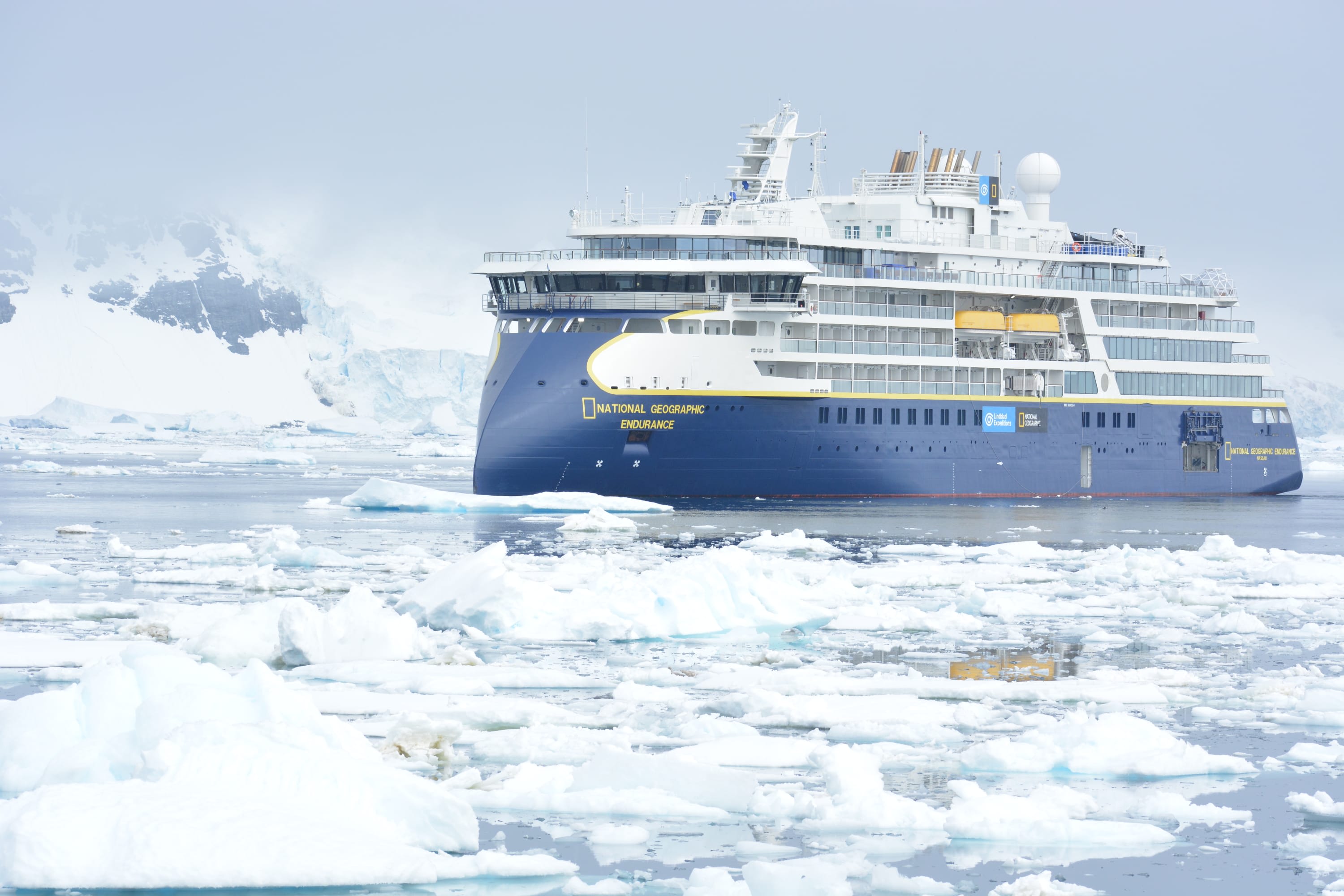 National Geographic Explorer ship in Antarctica, surrounded by floating ice