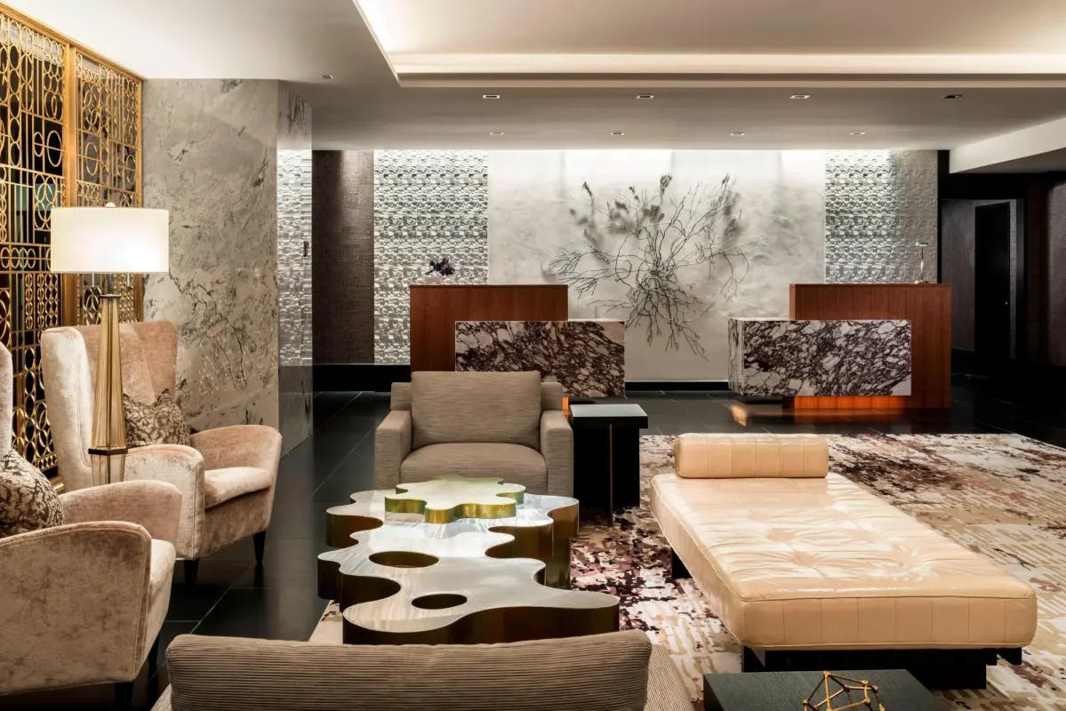 a swanky lobby with a wooden coffee table and large modular furniture