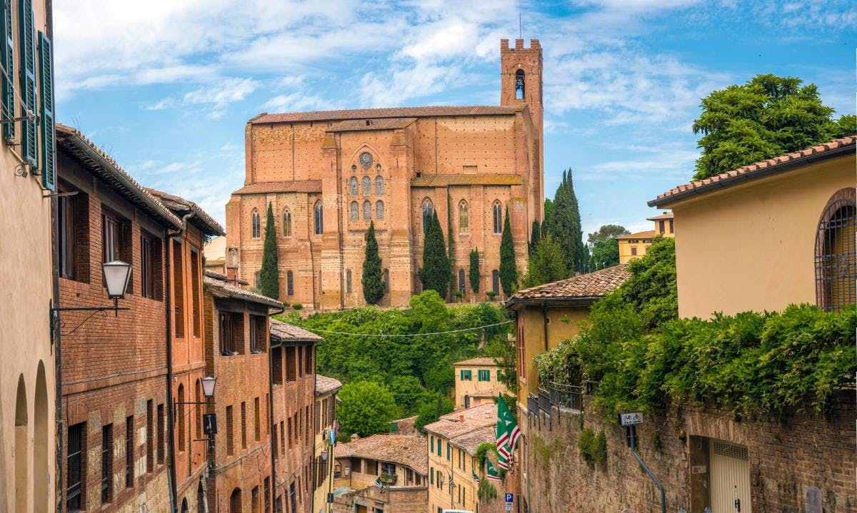Medieval architecture on hills in Tuscan city of Siena, Italy on a sunny day.
