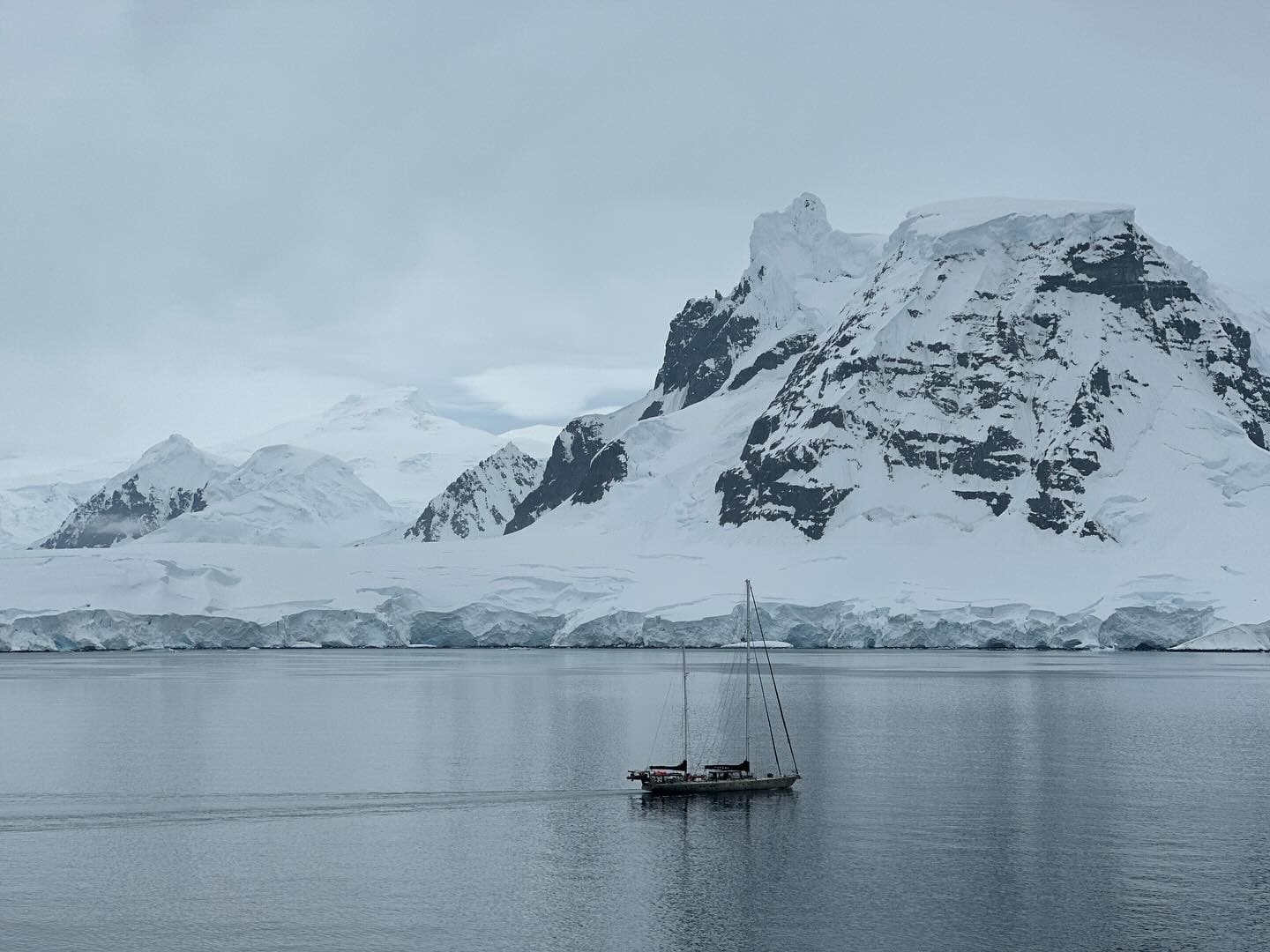 Picture of a boat in lake with beautiful snow covered mountains view