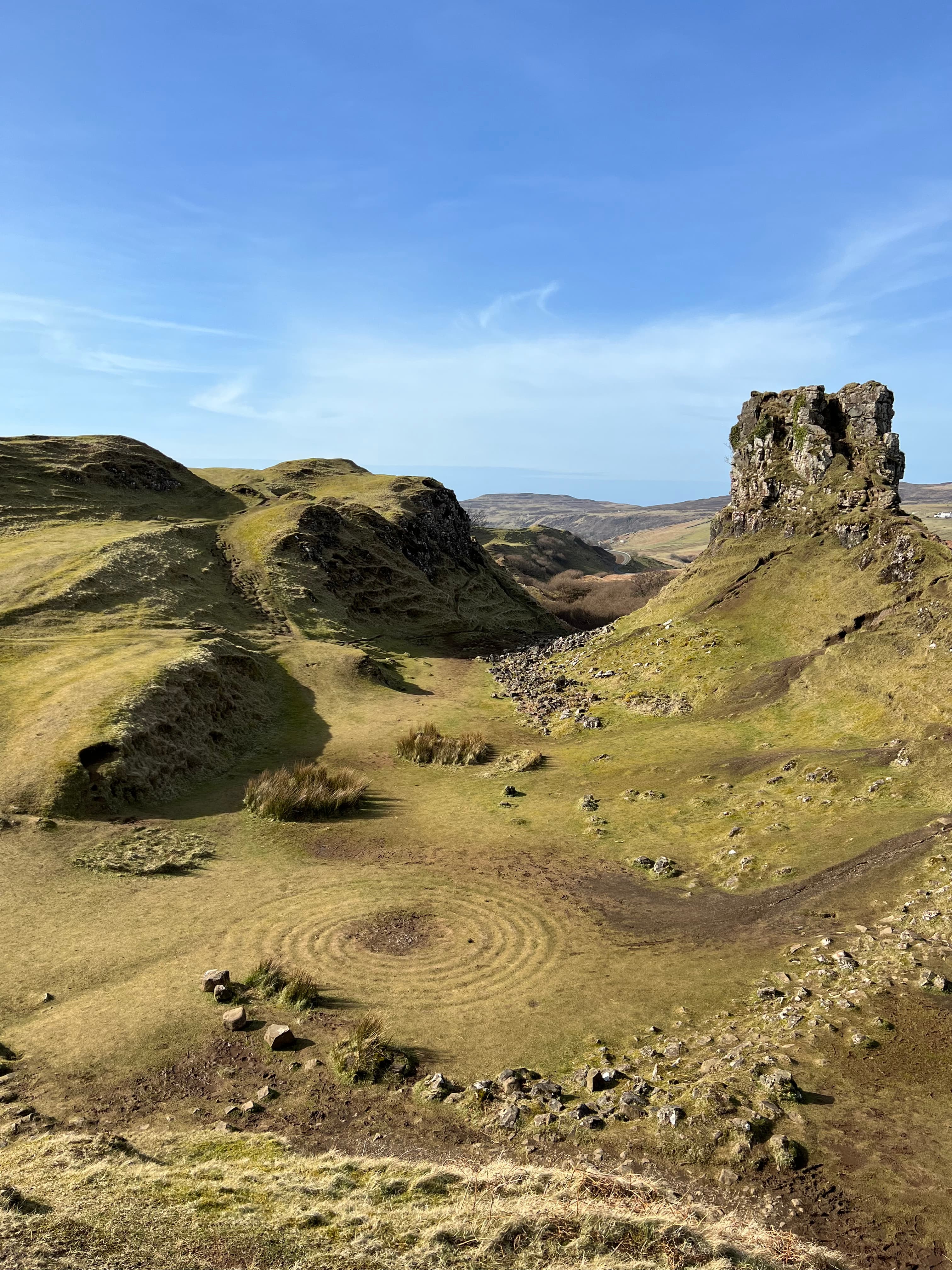 The Fairy Glen presents a charming miniature landscape with grassy, cone-shaped hills.
