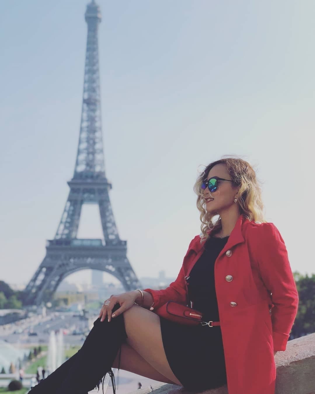 Posing for a picture with Eiffel Tower in the background