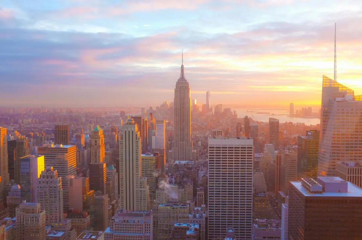 The New York City skyline at sunrise, with the Empire State Building prominently centered