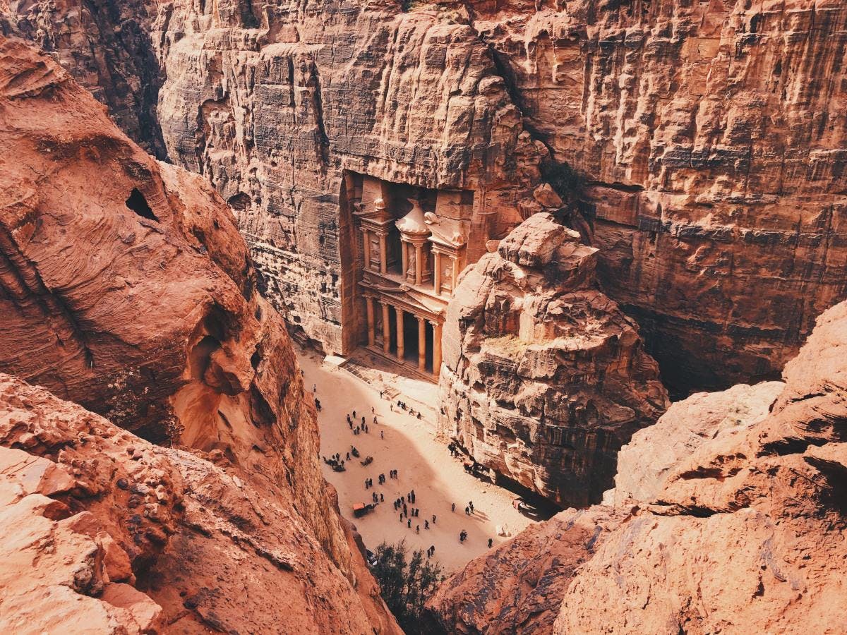 Archeological city of Petra within red rock formations.