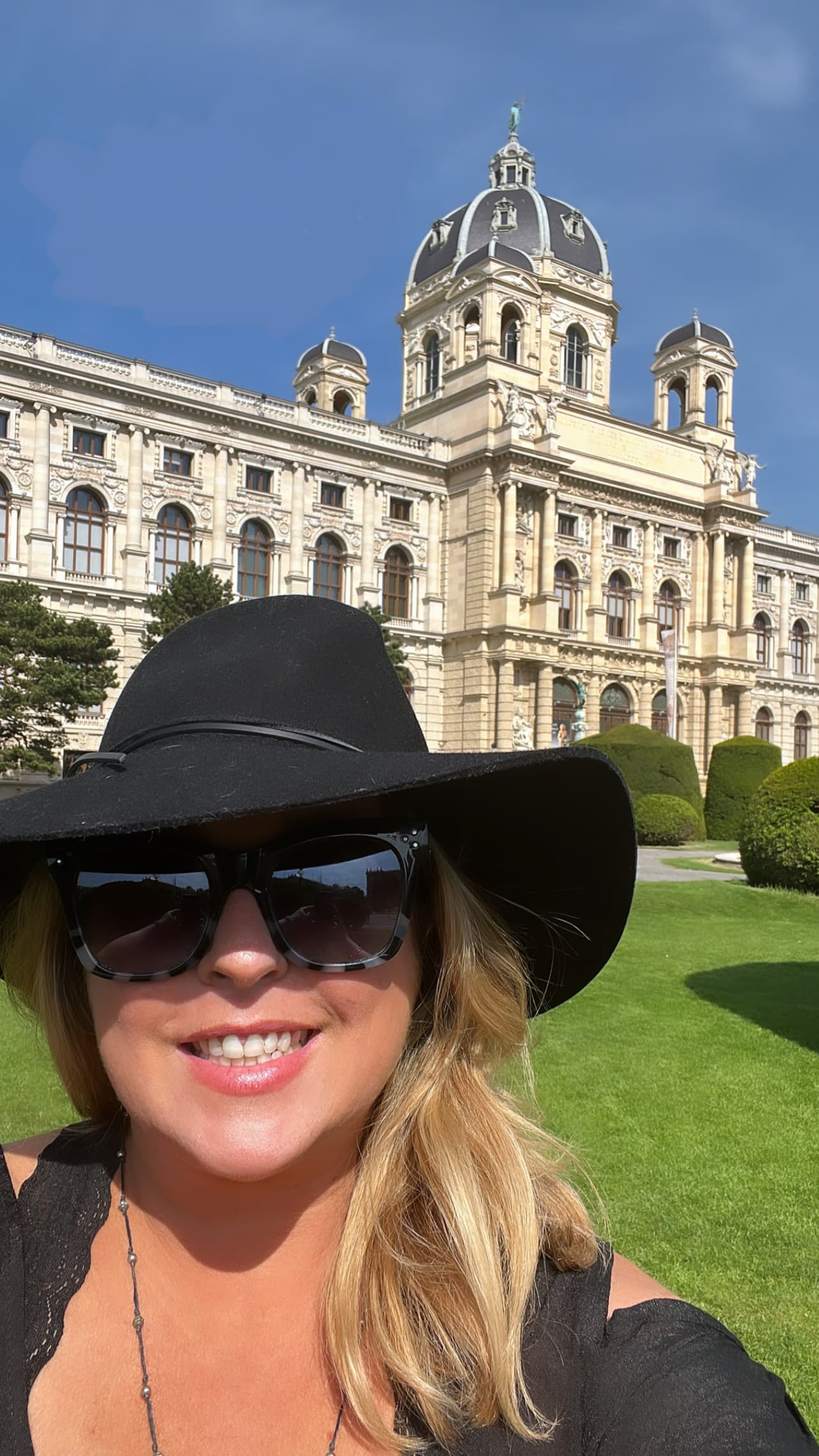 Shuana taking selfie in front of a building
