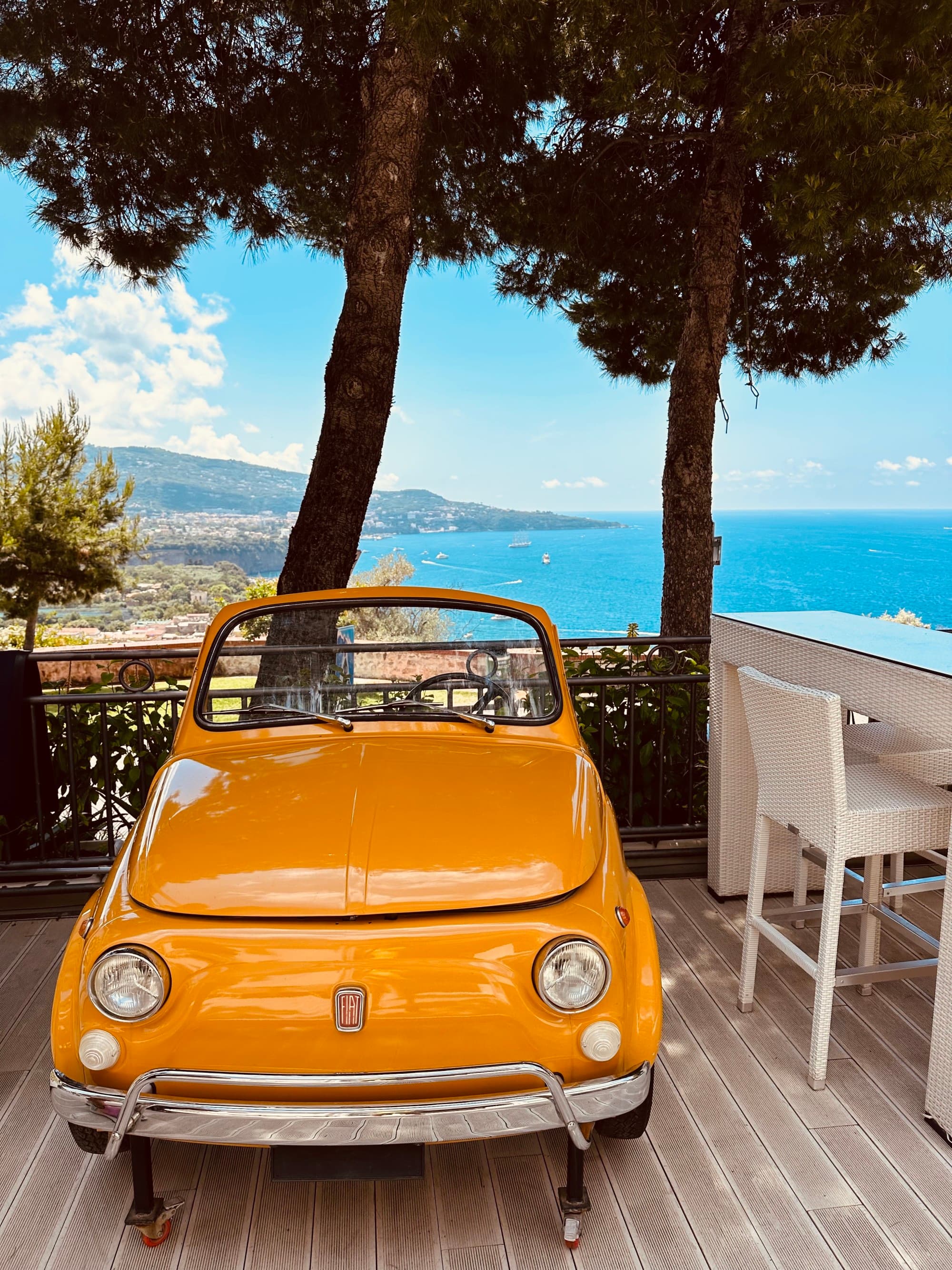 old orange car on a wooden deck