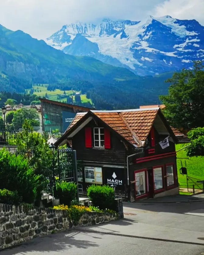 Image of a quaint house with beautiful mountains in the back