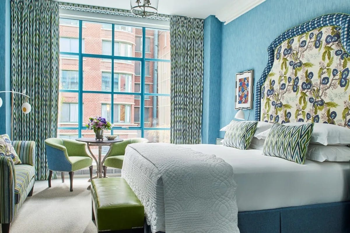 a brightly colored bedroom filled with blues and greens