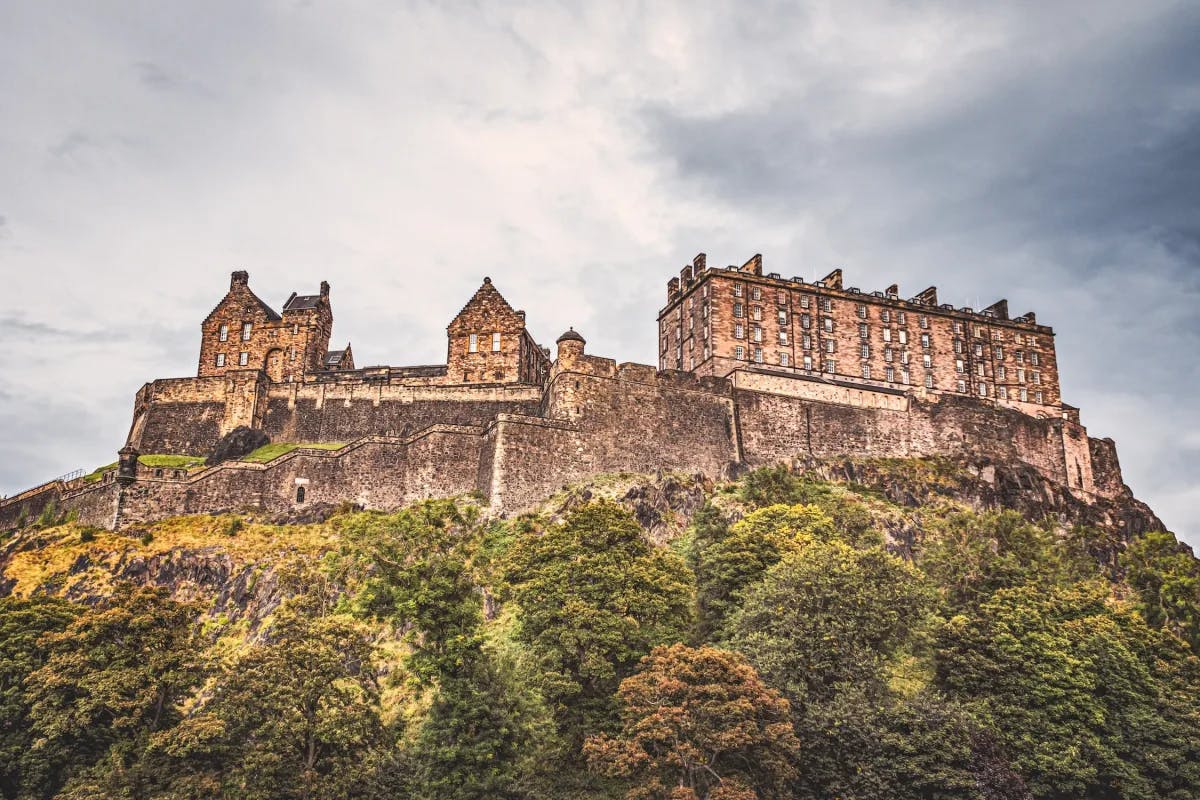 Edinburgh Castle is a majestic and iconic fortress perched on an ancient volcanic rock, overlooking Scotland's capital city, steeped in history and commanding breathtaking views.