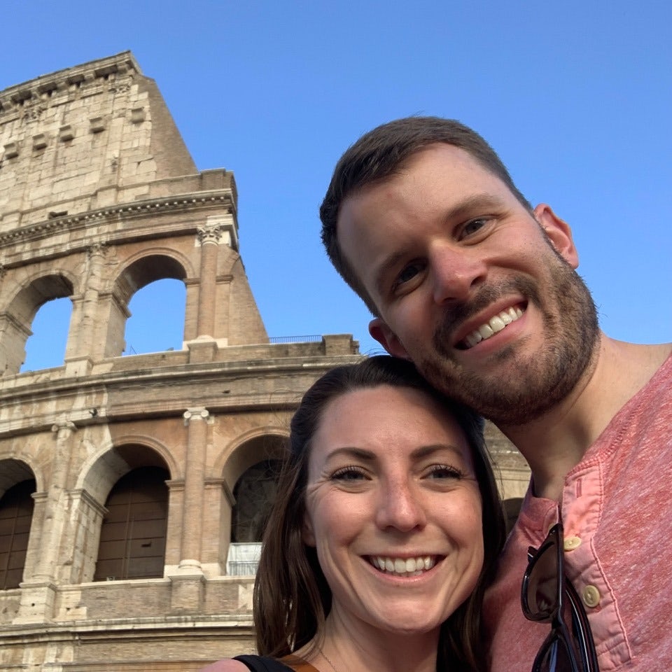 Travel Advisor Cameron Bradley with his partner in front of the Colosseum in Rome.