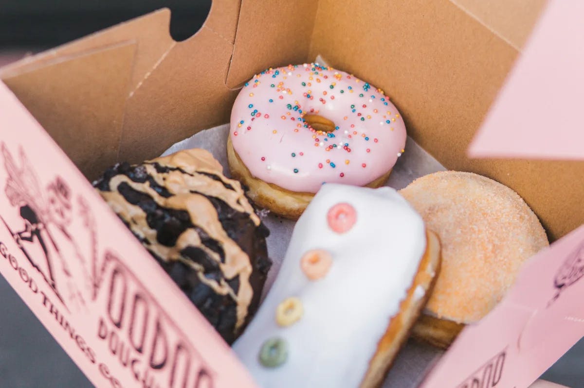 a pink box filled with brightly colored pastries