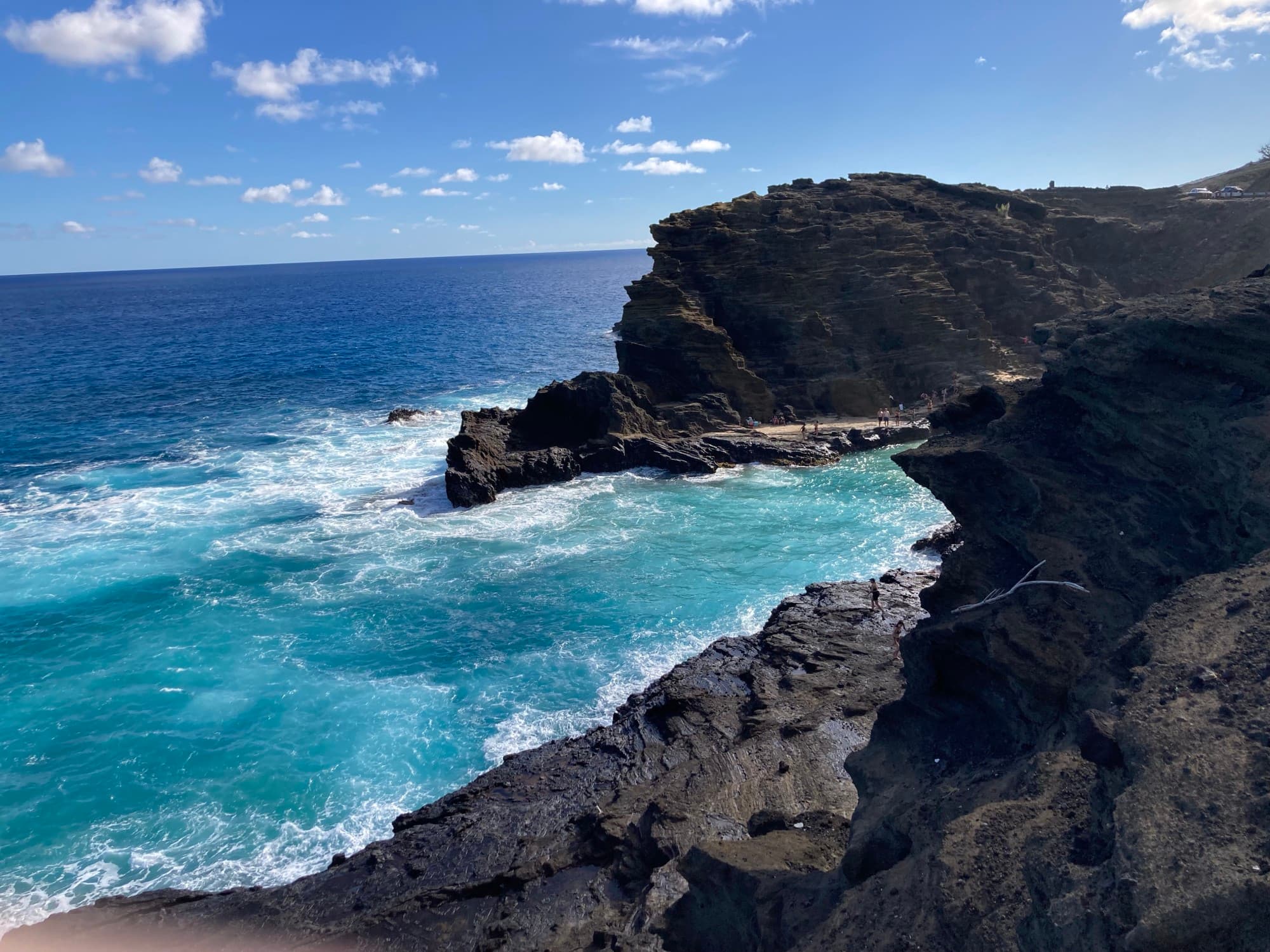 An ocean with rocky cliffs.