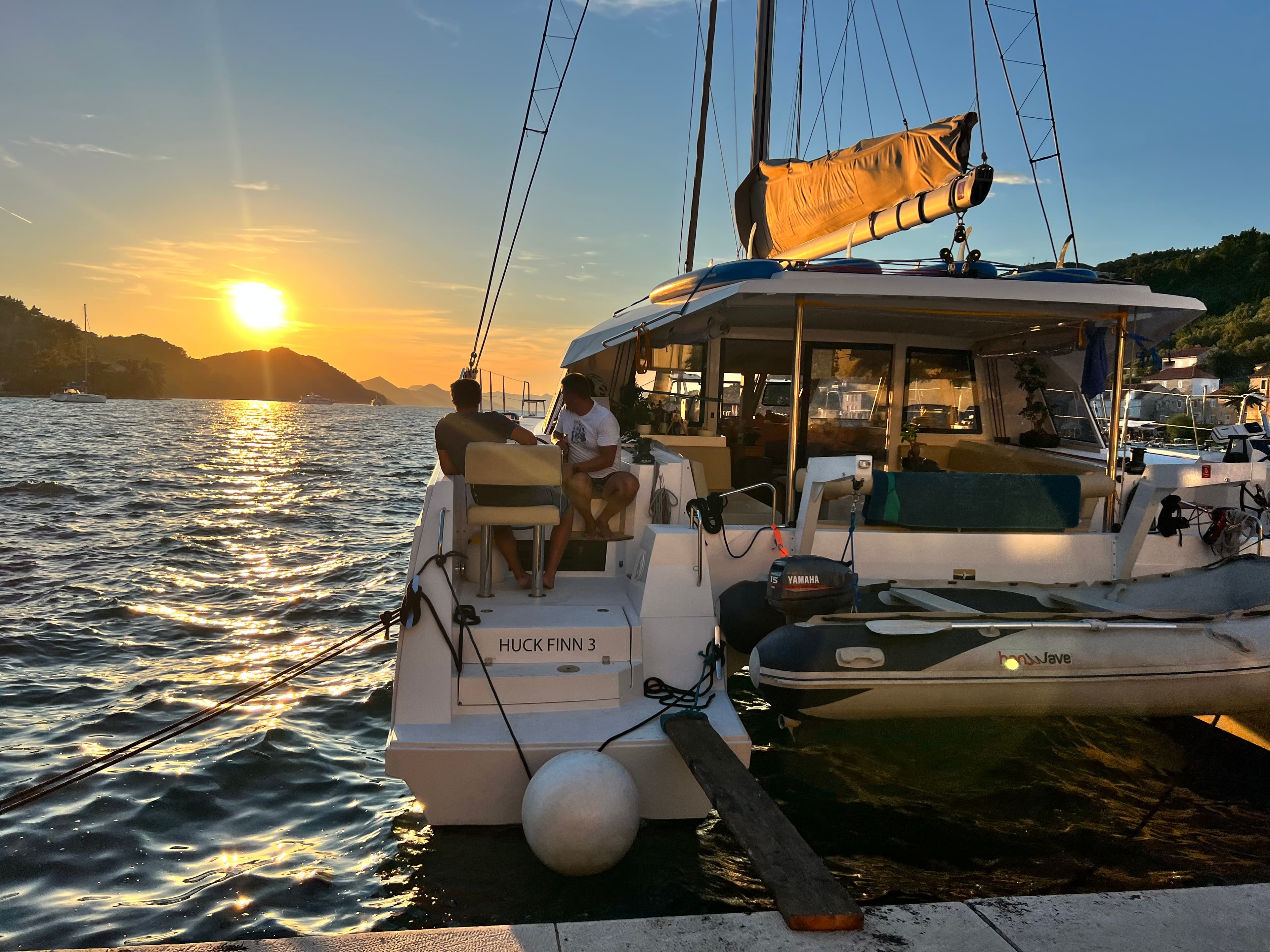 A boat ride on the rippling blue water as the sun sets in the background