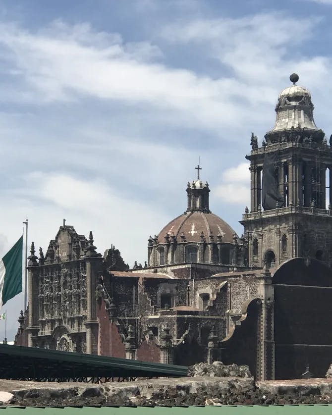 A picture of Plaza de la Constitución with the Mexican flag in front of it