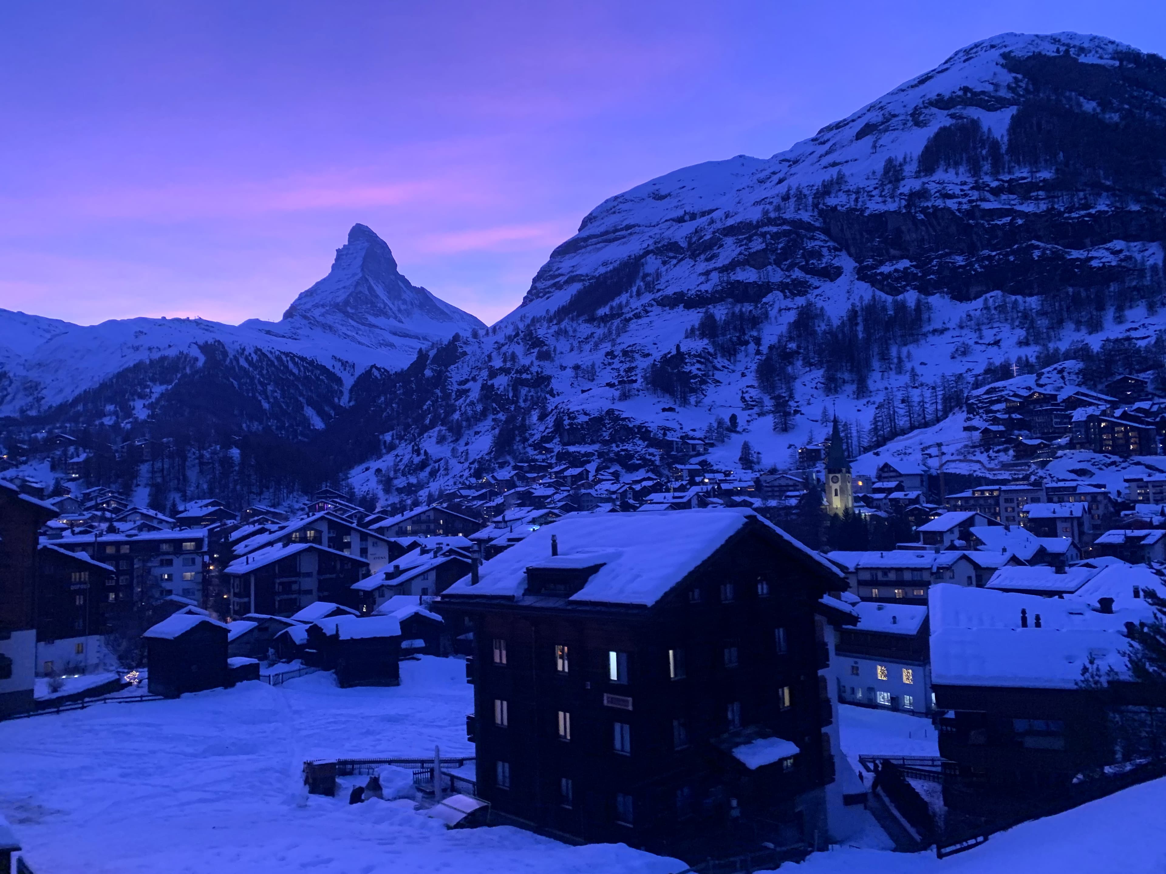 Spectacular view of mountains and houses covered in snow