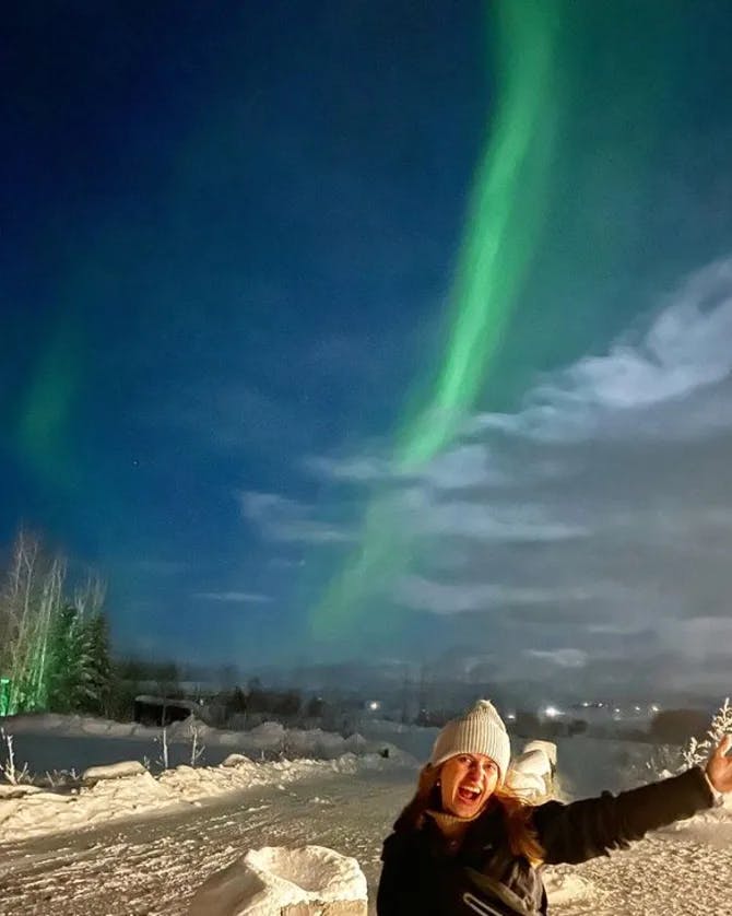 carolina in iceland with green light on the sky