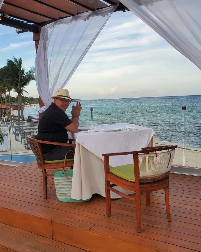 Picture of man dine in with a beautiful sea view