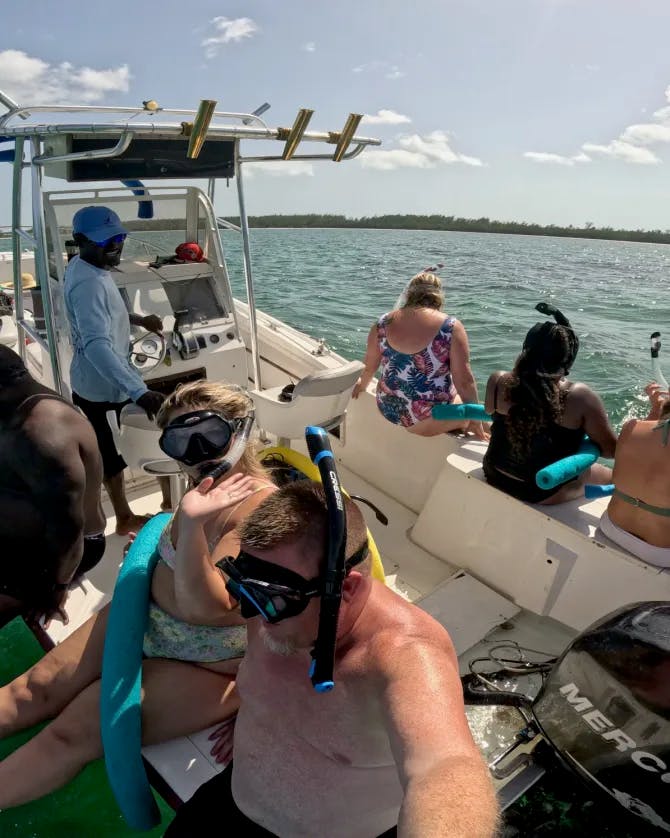 Picture of people on a boat ready to dive into water with scuba gear on 