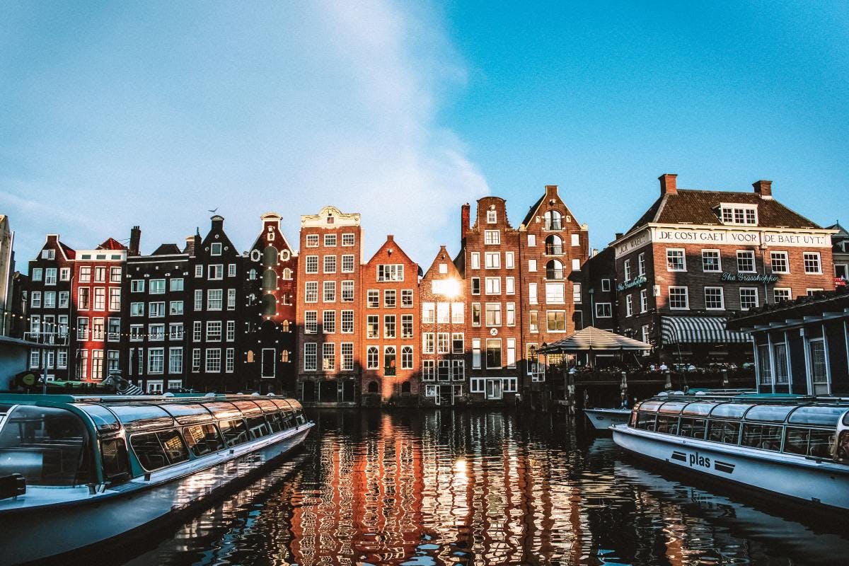 Brick buildings overlooking the water on a sunny day in Europe
