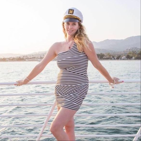 Travel advisor Melissa Laine in a striped dress and a sailor hat