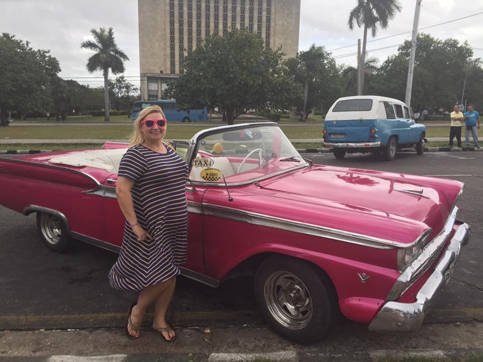 Advisor is posing with a pink car.