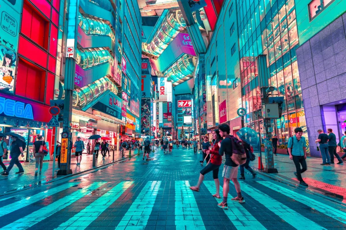 Night turns to day on this bustling Tokyo street lined with the signs of well-known Japanese brands, like Sega and Mitsubishi, line the walls