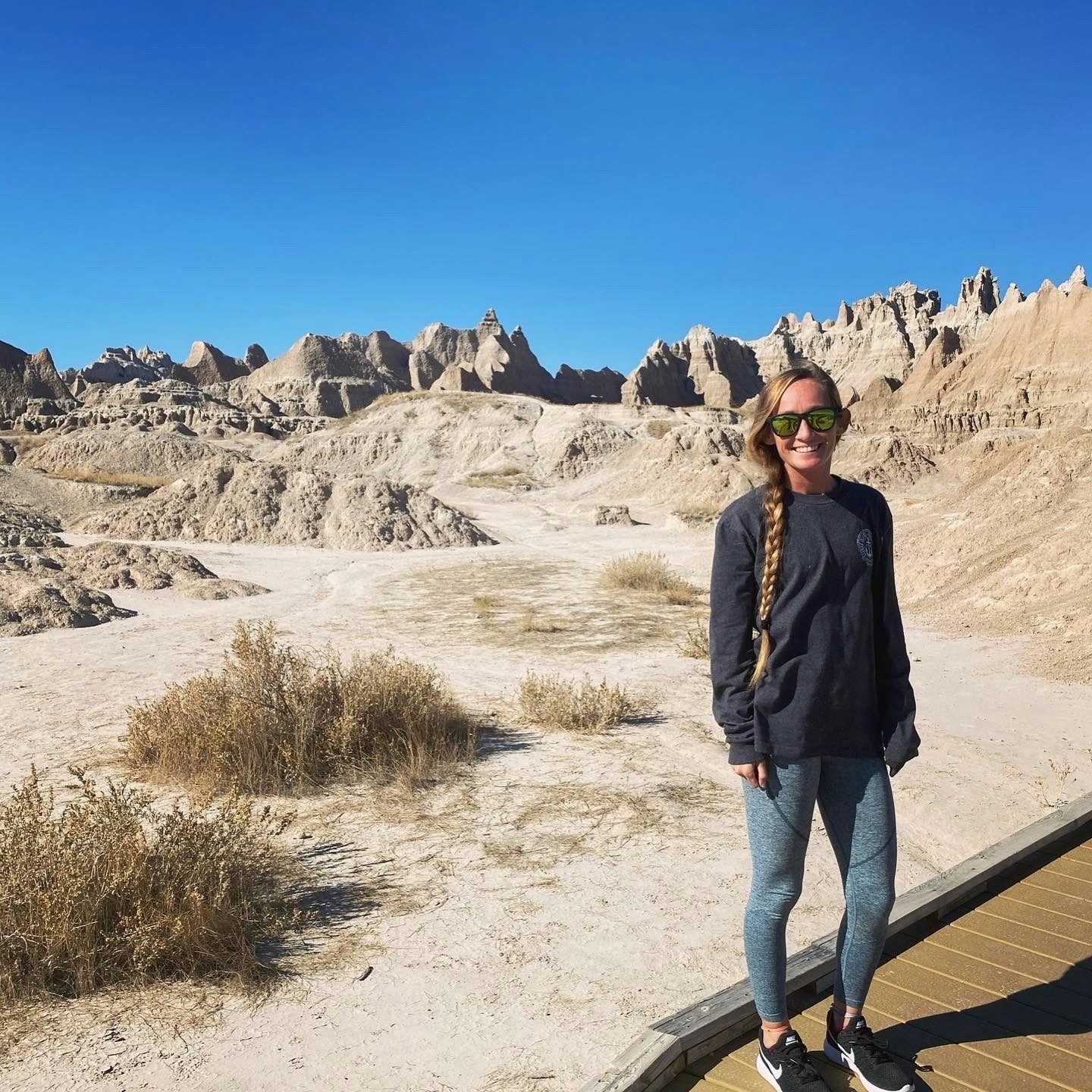 Travel Advisor Amanda Steiner in workout gear standing in front of a national park.