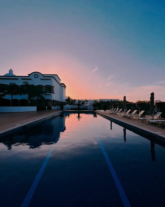 A beautiful view of pool at sunset