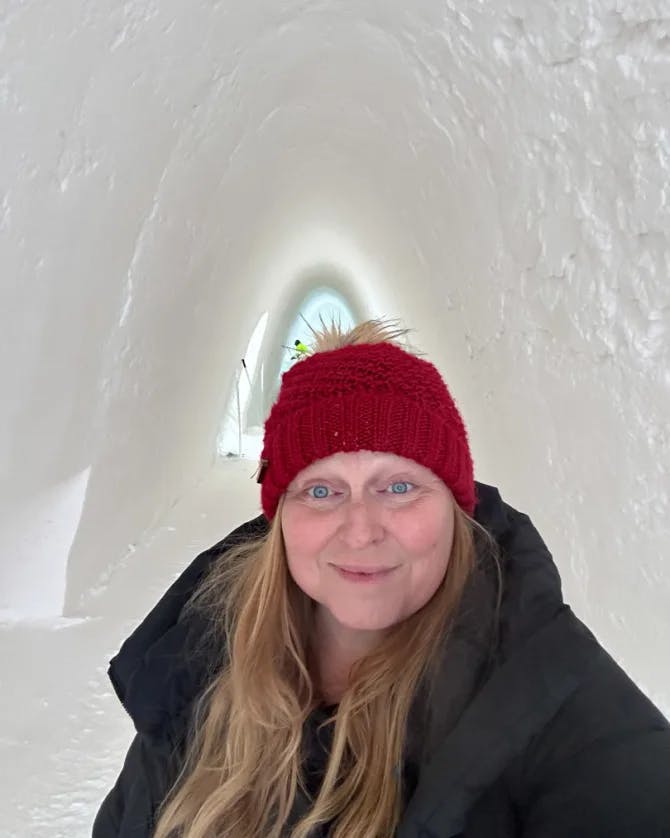 Karilyn taking a selfie of herself inside of an ice cave. 