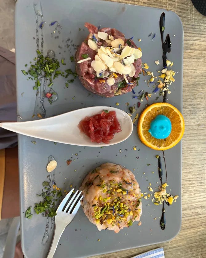 Aesthetically plated and colorful food on top of a wooden table 
