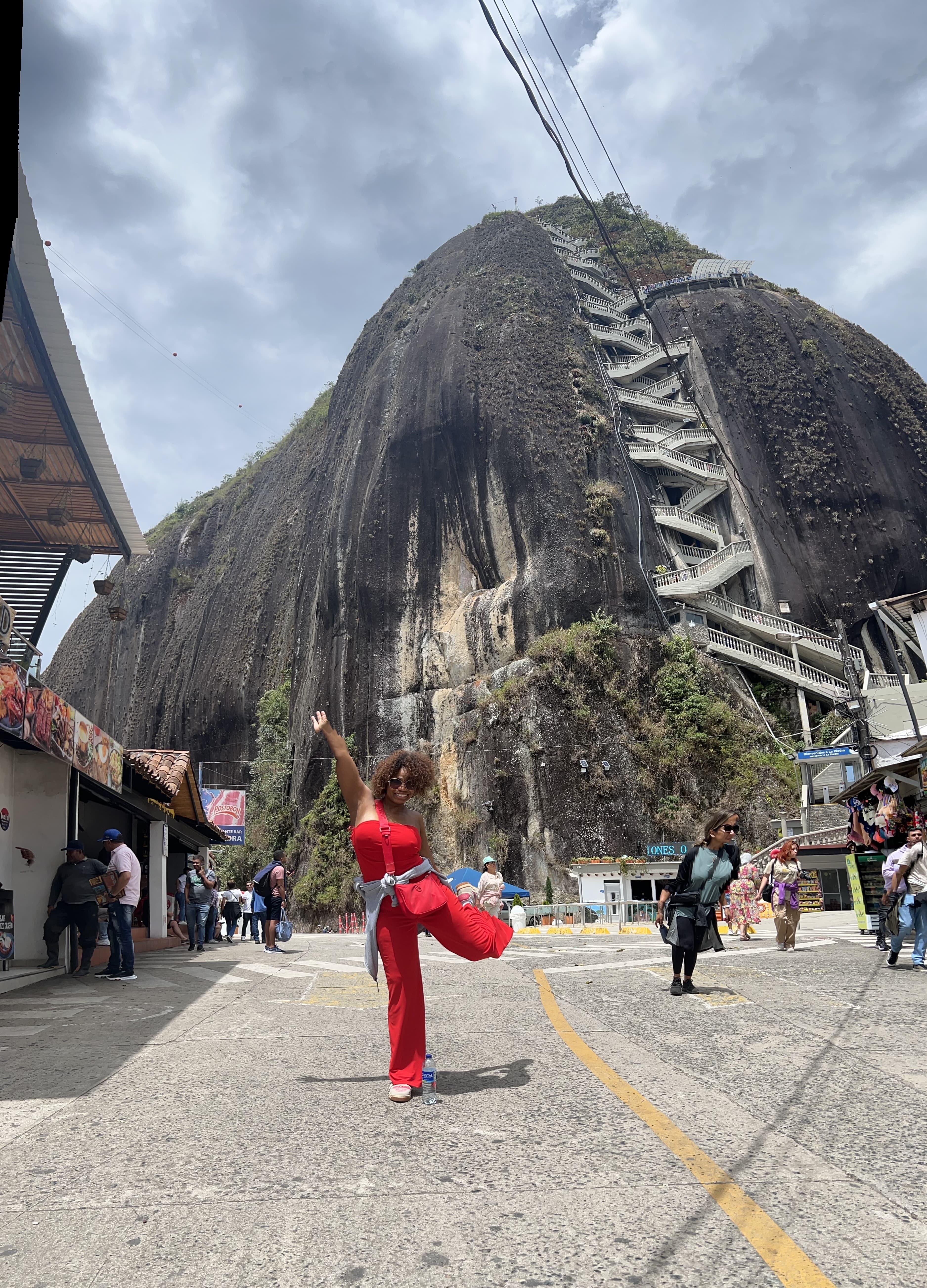 Erika posing in front of mountain covered in greenery.