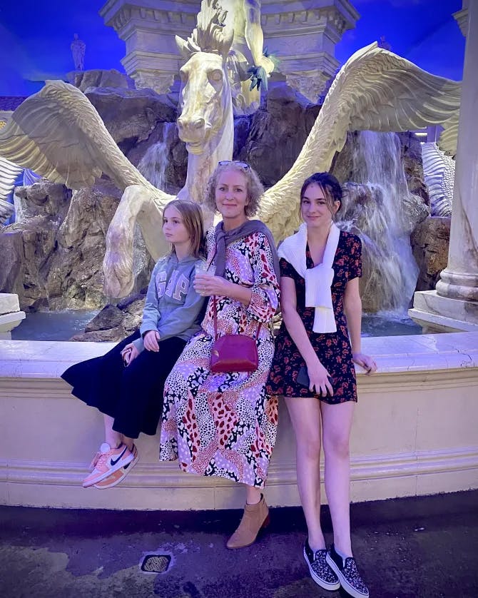Posing for a photo in front of a statue in Las Vegas